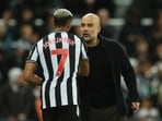 Manchester City manager Pep Guardiola shakes hands with Newcastle United's Joelinton after the match 
