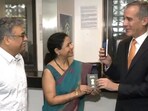 US Ambassador to India Eric Garcetti hands over passport to the one millionth visa holder in Delhi.