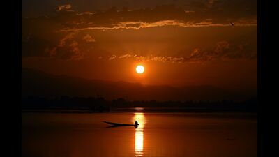 A fisherman prepares to cast his net in Dal Lake during sunset in Srinagar on Thursday. (AFP) A fisherman prepares to cast his net in Dal Lake during sunset in Srinagar on Thursday. (AFP)