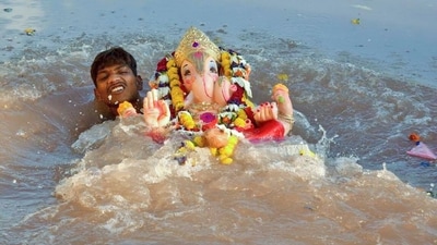 A devotee immerses the idol of Lord Ganesh in river Ganga on the occasion of Ganesh Visarjan in Prayagraj. (ANI) A devotee immerses the idol of Lord Ganesh in river Ganga on the occasion of Ganesh Visarjan in Prayagraj. (ANI)