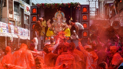 Devotees throw colours in celebration during a procession of Lord Ganesha for immersion during the conclusion of the Ganesh Chaturthi festival in Karad. (PTI) Devotees throw colours in celebration during a procession of Lord Ganesha for immersion during the conclusion of the Ganesh Chaturthi festival in Karad. (PTI)