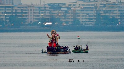 Devotees immerse idols of Hindu god Lord Ganesha in the Arabian Sea at Girgaon Chowpatty in Mumbai. (PTI) Devotees immerse idols of Hindu god Lord Ganesha in the Arabian Sea at Girgaon Chowpatty in Mumbai. (PTI)