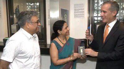 US Ambassador to India Eric Garcetti hands over passport to the one millionth visa holder in Delhi. (ANI) US Ambassador to India Eric Garcetti hands over passport to the one millionth visa holder in Delhi. (ANI)