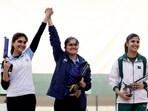 India's Palak celebrates with silver medallist India's Esha Singh as bronze medallist Pakistan's Kishmala Talat reacts after the Women's 10m Air Pistol Finals