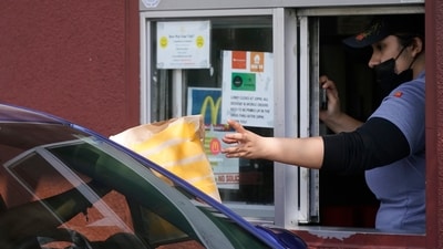 A customer picks up a meal bag at a McDonald's drive-thru window in Los Angeles, Thursday, Sept. 28, 2023.(AP Photo/Damian Dovarganes) (AP) A customer picks up a meal bag at a McDonald's drive-thru window in Los Angeles, Thursday, Sept. 28, 2023.(AP Photo/Damian Dovarganes) (AP)