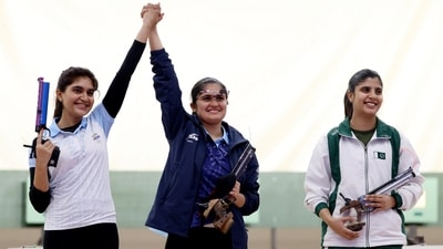 India's Palak celebrates with silver medallist India's Esha Singh as bronze medallist Pakistan's Kishmala Talat reacts after the Women's 10m Air Pistol Finals (REUTERS)