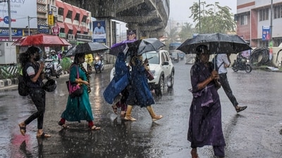 People walking through rain holding umbrellas in their hands. (HT File) People walking through rain holding umbrellas in their hands. (HT File)