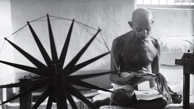 A 1964 photograph of Gandhi taken by Margaret Bourke White shows him reading clippings with a charkha in the foreground. (Photo courtesy: National Gandhi museum) A 1964 photograph of Gandhi taken by Margaret Bourke White shows him reading clippings with a charkha in the foreground. (Photo courtesy: National Gandhi museum)