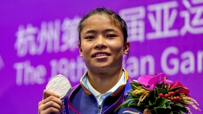 Hangzhou: India's Naorem Roshibina Devi with her silver medal poses for photographs during presentation ceremony (PTI) Hangzhou: India's Naorem Roshibina Devi with her silver medal poses for photographs during presentation ceremony (PTI)