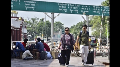 Stranded railway passengers walk away from the railway station in Amritsar on Friday. (HT Photo) Stranded railway passengers walk away from the railway station in Amritsar on Friday. (HT Photo)