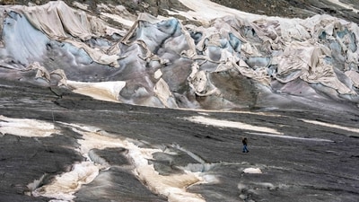 A team member of the Swiss Federal Institute of Technology passes the Rhone Glacier covered by sheets near Goms, Switzerland. A top glacier watcher has warned that a warm early summer and a heat wave last week could have caused severe glacier melt across Switzerland. (AP) A team member of the Swiss Federal Institute of Technology passes the Rhone Glacier covered by sheets near Goms, Switzerland. A top glacier watcher has warned that a warm early summer and a heat wave last week could have caused severe glacier melt across Switzerland. (AP)