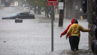 Residents walk through floodwaters during a heavy rain storm in the New York City suburb of Mamaroneck in Westchester County, New York, U.S., September 29, 2023. (Reuters)