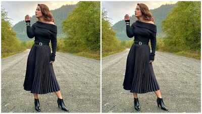 For her chic all-black look, Hina opted for a black knitted sweatshirt featuring an uneven neckline and full sleeves. She teamed it with a pleated knee-length black skirt. (Instagram/@realhinakhan) For her chic all-black look, Hina opted for a black knitted sweatshirt featuring an uneven neckline and full sleeves. She teamed it with a pleated knee-length black skirt. (Instagram/@realhinakhan)