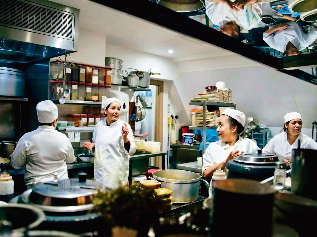 At Darjeeling Express, there’s a daily antakshari among the all-women kitchen team during prep. “I keep losing to the grandmothers because they know all the songs,” Khan says. At Darjeeling Express, there’s a daily antakshari among the all-women kitchen team during prep. “I keep losing to the grandmothers because they know all the songs,” Khan says.