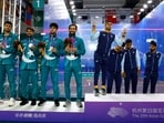 Gold medallists from team India react next to silver medallists from team Pakistan during the medal ceremony