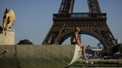 A man sunbaths at the Trocadero fountains in front of the Eiffel Tower in Paris (File) A man sunbaths at the Trocadero fountains in front of the Eiffel Tower in Paris (File)