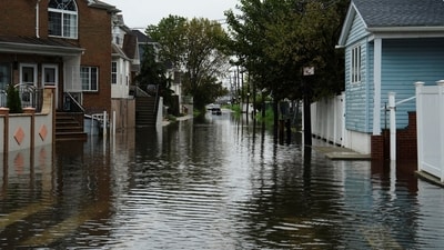 Floodwaters fill the residential street in the Hamilton Beach neighborhood in the Queens borough of New York City. (REUTERS)
