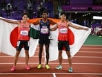 Gold medallists India's Avinash Sable celebrates after winning the men's 3000m steeplechase final with silver medallist Japan's Ryoma Aoki and bronze medallist Japan's Seiya Sunada