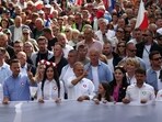 Donald Tusk, the leader of the largest opposition grouping Civic Coalition (KO) and Rafal Trzaskowski, mayor of Warsaw march in front of the Polish national flag during the "Marsz Miliona Serc" rally, in Warsaw, Poland.