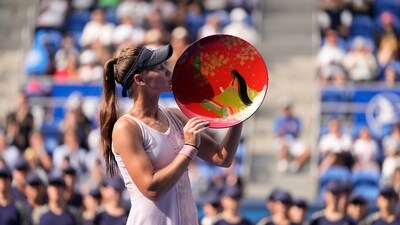 Veronika Kudermetova of Russia kisses her champion trophy during the award ceremony for the singles after defeating Jessica Pegula of the U.S. in the Pan Pacific Open tennis tournament (AP)