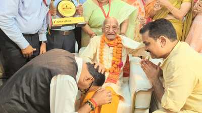 Deputy CM Brajesh Pathak and social welfare minister Asim Arun seek blessings of an elderly at a function on the International Day of Older Persons on Sunday. (HT photo)
