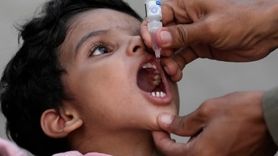 A health worker administers a polio vaccine to a child at a railway station in Karachi, Pakistan. (AP) A health worker administers a polio vaccine to a child at a railway station in Karachi, Pakistan. (AP)