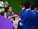 India's Jyothi Yarraji speaks to officials following a false start by China's Yanni Wu during the women's 100m hurdles final 