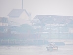 Students ride a wooden boat through the Ogan river, which is covered by smog due to wildfires, in Palembang, South Sumatra province, Indonesia.