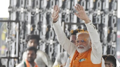 Prime Minister Narendra Modi waves to his supporters during a public meeting. (ANI Photo) Prime Minister Narendra Modi waves to his supporters during a public meeting. (ANI Photo)