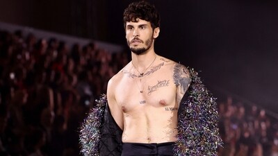 French model and singer Baptiste Giabiconi went shirtless on the runway for the L'Oreal Paris show near the Eiffel Tower. He wore a long coat embellished with multi-coloured tassels. Black baggy pants with a quirky belt rounded off his look.&nbsp; (REUTERS)