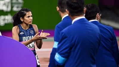 India's Jyothi Yarraji speaks to officials following a false start by China's Yanni Wu during the women's 100m hurdles final (REUTERS)