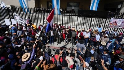 Protestors demand the resignation of Attorney General Consuelo Porras and prosecutor Rafael Curruchiche outside the Attorney General's Office in Guatemala City, Monday. (AP) Protestors demand the resignation of Attorney General Consuelo Porras and prosecutor Rafael Curruchiche outside the Attorney General's Office in Guatemala City, Monday. (AP)