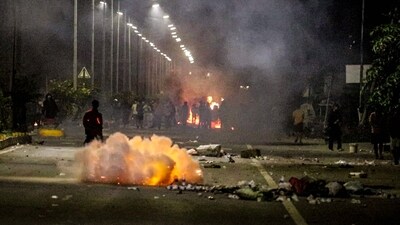Security personnel fire tear gas as miscreants protest near the family home of chief minister N Biren Singh, (AFP) Security personnel fire tear gas as miscreants protest near the family home of chief minister N Biren Singh, (AFP)