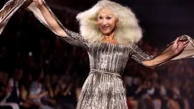 Helen Mirren was a vision to behold in a silver sequinned gown at the Paris Fashion Week L'Oreal Paris show. Her ensemble featured a figure-skimming silhouette, long cape sleeves, and a cinched waistline. Wild silver-blonde hair and striking glam rounded it off.&nbsp; (REUTERS)