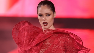 Coco Rocha wore a lace-embroidered red see-through gown featuring a structured neckline and full-length sleeves. Her striking glam stole the show.&nbsp; (Vianney Le Caer/Invision/AP)