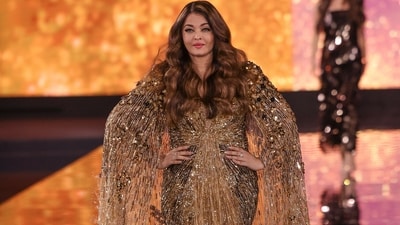 Aishwarya Rai sparkles and shines during the L'Oreal Paris show at the Paris Fashion Week, dressed in a golden cape gown. The star strutted the runway in the sparkly creation and debuted her brand-new blonde highlights. Here she poses for the camera during the ramp walk.&nbsp; (Vianney Le Caer/Invision/AP)