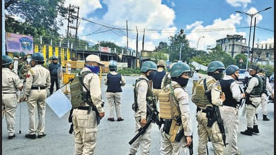 Security personnel stand guard during a protest rally by school students against the killing of two Meitei youths by suspected Kuki Zo militants, at Moirangkhom in Imphal West district on Wednesday. (PTI) Security personnel stand guard during a protest rally by school students against the killing of two Meitei youths by suspected Kuki Zo militants, at Moirangkhom in Imphal West district on Wednesday. (PTI)