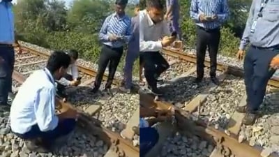 Screengrab from video showing railway officials removing stones, rods from tracks (ANI) Screengrab from video showing railway officials removing stones, rods from tracks (ANI)