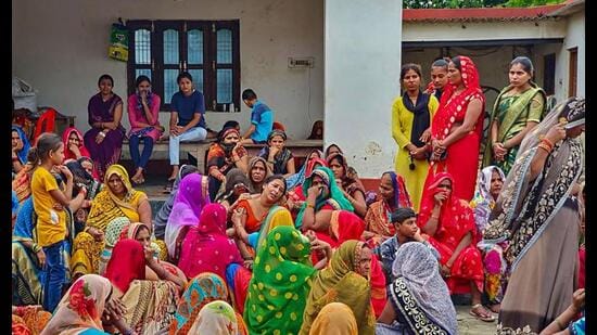 •Family members mourn after six people, including five of a family, were killed over a property dispute, in Deoria district, Monday. (PTI Photo)