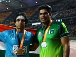 Gold medallist India's Neeraj Chopra celebrates after the final with silver medallist Pakistan's Arshad Nadeem(REUTERS)