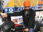 Hardeep Singh Nijjar, wanted in India for targeted killings in Punjab, poses on a motorcycle in front of the Sikhs For Justice float in Surrey.