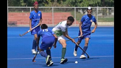 (In blue) Round Glass Chachrari (in white) Malwa Academy Hockey team players in action during the boys final match in Ludhiana on Tuesday. (Gurpreet Singh/HT)