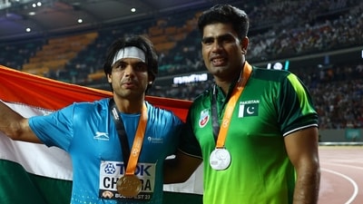 Gold medallist India's Neeraj Chopra celebrates after the final with silver medallist Pakistan's Arshad Nadeem (REUTERS)