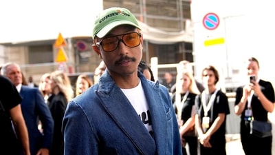 Pharrell Williams arrives. The designs were a riot of colors, ludic patterns, and subtle riffs on harlequins. A visual feast that kept the eyes and iPhones flitting from one ensemble to the next. (AP) Pharrell Williams arrives. The designs were a riot of colors, ludic patterns, and subtle riffs on harlequins. A visual feast that kept the eyes and iPhones flitting from one ensemble to the next. (AP)
