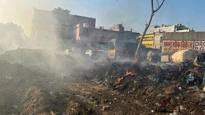 Garbage burns at the dump site at Sector 12 in Gurugram on Wednesday. (Parveen Kumar/HT Photo)