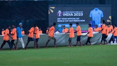 Groundsmen pull the covers as rain interrupts the ICC Cricket World Cup warm-up match between Afghanistan and Sri Lanka in Guwahati (AP) Groundsmen pull the covers as rain interrupts the ICC Cricket World Cup warm-up match between Afghanistan and Sri Lanka in Guwahati (AP)