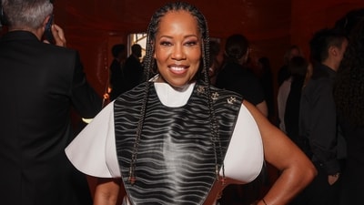 Regina King attended the Louis Vuitton show in a structured cropped blouse featuring quirky sleeves, a front printed leather panel, and an asymmetric hem. She styled the top with deep red-coloured balloon pants, high heels, a printed box clutch, rings, a bracelet, kohl-adorned eyes, caramel lip gloss, and a dewy base. (Vianney Le Caer/Invision/AP) Regina King attended the Louis Vuitton show in a structured cropped blouse featuring quirky sleeves, a front printed leather panel, and an asymmetric hem. She styled the top with deep red-coloured balloon pants, high heels, a printed box clutch, rings, a bracelet, kohl-adorned eyes, caramel lip gloss, and a dewy base. (Vianney Le Caer/Invision/AP)