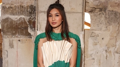 Gemma Chan served another elegant sartorial moment at the Louis Vuitton show in Paris. She wore a green mini dress featuring ruffled pleats, a cream-coloured faux leather panel on the torso, a knee-length hem, and a figure-skimming silhouette. She wore it with high heels, a top-handle LV monogram bag, minimal makeup picks, and a half-tied hairdo. (Vianney Le Caer/Invision/AP) Gemma Chan served another elegant sartorial moment at the Louis Vuitton show in Paris. She wore a green mini dress featuring ruffled pleats, a cream-coloured faux leather panel on the torso, a knee-length hem, and a figure-skimming silhouette. She wore it with high heels, a top-handle LV monogram bag, minimal makeup picks, and a half-tied hairdo. (Vianney Le Caer/Invision/AP)