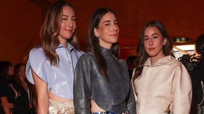 The Haim sisters - Este Haim, Danielle Haim and Alana Haim - pose for the paparazzi at the Louis Vuitton Spring/Summer 2024 womenswear fashion show. The musicians came dressed in head-to-toe Louis Vuitton ensembles. (Vianney Le Caer/Invision/AP) The Haim sisters - Este Haim, Danielle Haim and Alana Haim - pose for the paparazzi at the Louis Vuitton Spring/Summer 2024 womenswear fashion show. The musicians came dressed in head-to-toe Louis Vuitton ensembles. (Vianney Le Caer/Invision/AP)