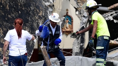 Segura and others were near a side of the church when the roof fell Sunday and managed to escape with relatively minor injuries. (AFP)